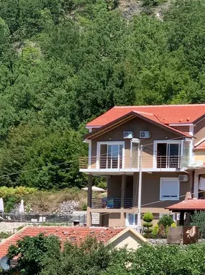 a large house with a red roof at Brioni in Virpazar