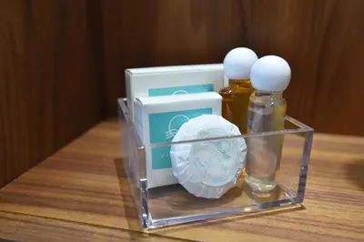a glass container with two bottles of essential oils on a table at Vistamar Hotel & Apartments in Budva