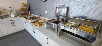 a kitchen with several trays of food on a counter at Casa Al Mare in Ulcinj