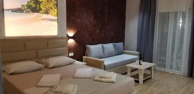 a bedroom with a bed and a couch and a chair at Casa Al Mare in Ulcinj