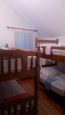 a bedroom with two bunk beds and a window at Vacation home in Virpazar