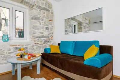 a living room with a couch and a table at La Rocca Apartment Old Town Kotor in Kotor