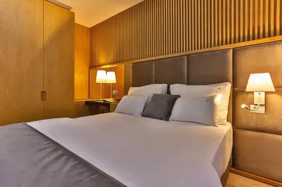 a bedroom with a large white bed with two pillows at Villa Dvor Kornic in Budva