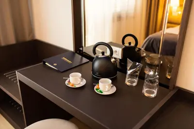 a table with two tea pots and cups on it at Villa Dvor Kornic in Budva