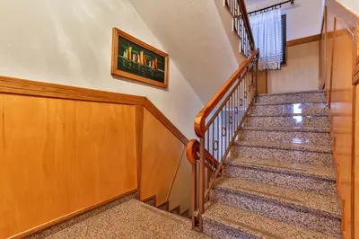 a staircase in a home with wooden railings at Villa Dvor Kornic in Budva