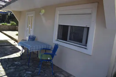 a table and chairs sitting on a porch with a window at OLD TOWN STUDIOS in Budva