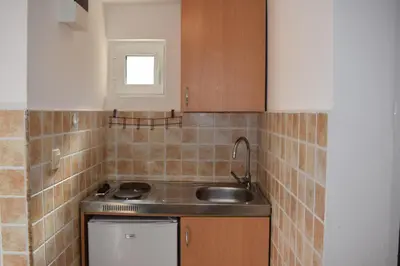 a small kitchen with a sink and a stove at OLD TOWN STUDIOS in Budva