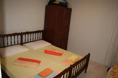 a bedroom with a bed with towels on it at Beachfront apartment in Becici,Rafilovici,Budva in Budva