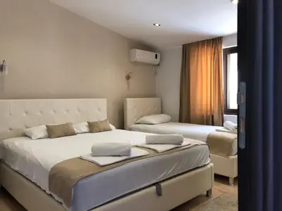 a bedroom with two beds and a window at Days Inn Apartments in Ulcinj