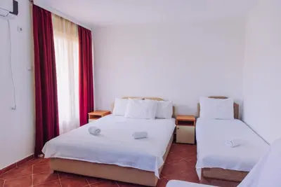 a hotel room with two beds and a window at Apartmani Lasta in Dobra Voda