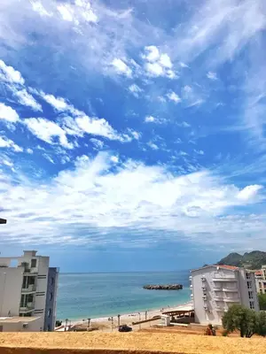 a view of a beach with buildings and the ocean at Apartmani Lasta in Dobra Voda