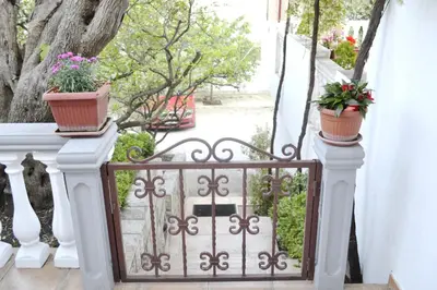 a white railing with two potted plants on it at Apartments Irena in Becici