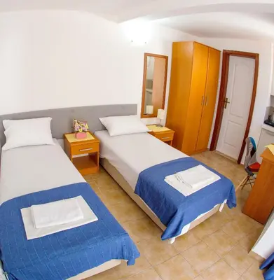 a hotel room with two beds and a mirror at Fisherman House Apartments in Rafailovici