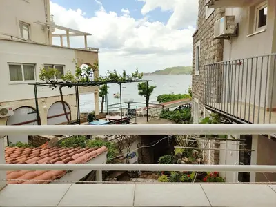 a view of the water from a balcony of a building at Fisherman House Apartments in Rafailovici