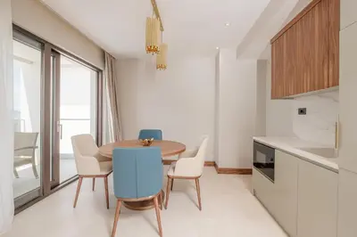 a dining room with a table and chairs in a kitchen at ĀNANTI Resort, Residences & Beach Club - The Leading Hotels of the World in Sveti Stefan