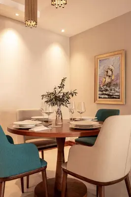 a dining room with a wooden table and chairs at ĀNANTI Resort, Residences & Beach Club - The Leading Hotels of the World in Sveti Stefan