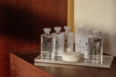 a shelf with four bottles on top at ĀNANTI Resort, Residences & Beach Club - The Leading Hotels of the World in Sveti Stefan
