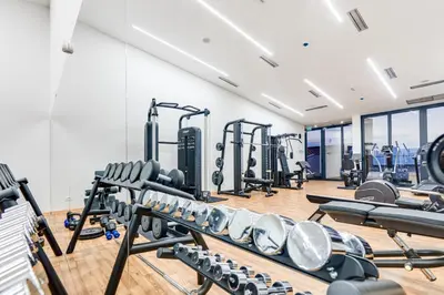 a gym with lots of treadmills and machines at ĀNANTI Resort, Residences & Beach Club - The Leading Hotels of the World in Sveti Stefan