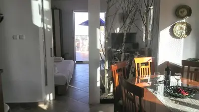 a dining room and living room with a table and chairs at Apartments Mila Krimovica in Krimovice