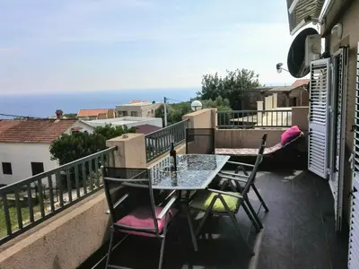 a patio with a table and chairs on a balcony at Apartments Mila Krimovica in Krimovice