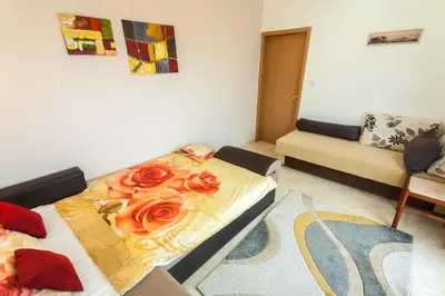 a living room with a bed with roses on it at Apartments Mila Krimovica in Krimovice