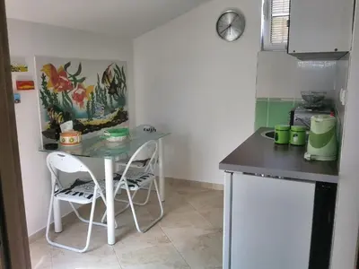 a small kitchen with a table and two chairs at Apartments Mila Krimovica in Krimovice