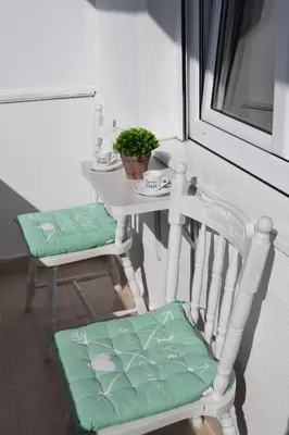 a white table and two chairs with a table and a table and a tableablish at Apartman Bloom in Bar