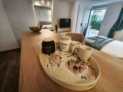 a tray with two cups on a table in a room at Guest house Villa Slavica in Sveti Stefan