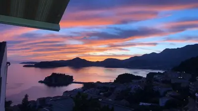 a view of a lake at sunset at Guest house Villa Slavica in Sveti Stefan