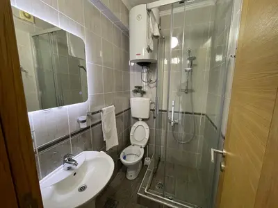 a bathroom with a toilet and a sink and a shower at Guest house Villa Slavica in Sveti Stefan