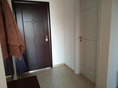 a brown door in a room with a closet at Faith Apartman in Budva