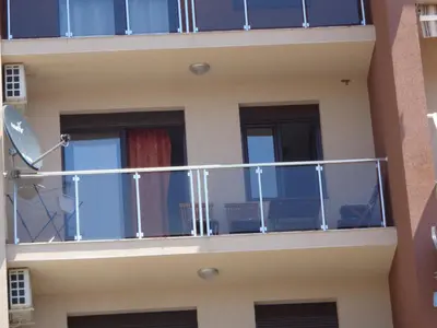 a balcony of a building with blue windows at Faith Apartman in Budva