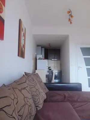 a living room with a bed and a kitchen at Faith Apartman in Budva