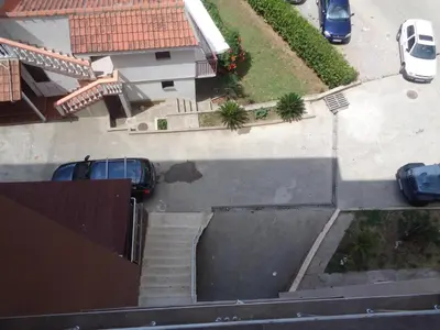 an aerial view of a parking lot with a car in a driveway at Faith Apartman in Budva
