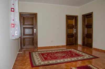 a room with two doors and a rug on the floor at Villa Ramonte in Cetinje