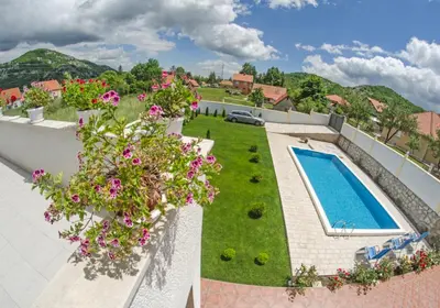 an aerial view of a house with a swimming pool and flowers at Villa Ramonte in Cetinje
