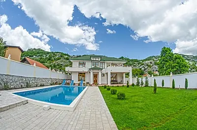 a house with a swimming pool in a yard at Villa Ramonte in Cetinje