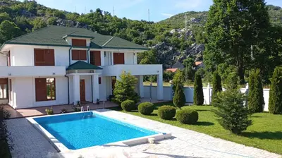 a house with a swimming pool in the yard at Villa Ramonte in Cetinje