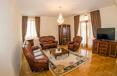a living room with leather furniture and a tv at Villa Ramonte in Cetinje