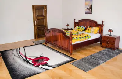 a bedroom with a bed with a red flower on it at Villa Ramonte in Cetinje