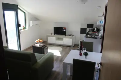 a living room with a couch and a table at Forest Apartments in Kotor