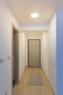 an empty hallway with a door and a rug at Central Budva apartment in Budva