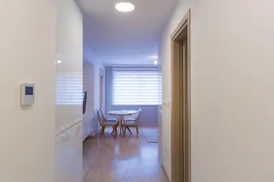 a hallway with a table and chairs in a room at Central Budva apartment in Budva