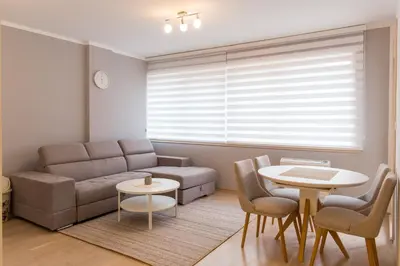 a living room with a couch and a table and chairs at Central Budva apartment A10 in Budva