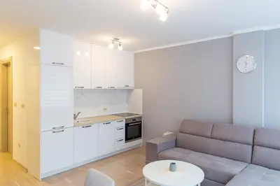 a living room with a couch and a table at Central Budva apartment A10 in Budva