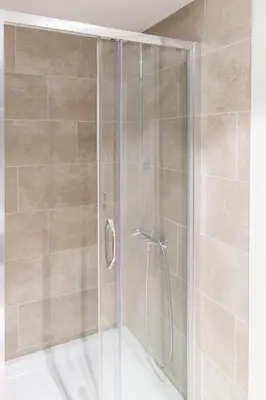 a shower with a glass door in a bathroom at Central Budva apartment C15 in Budva