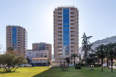 two tall buildings in a city with a park at Central Budva apartment C15 in Budva