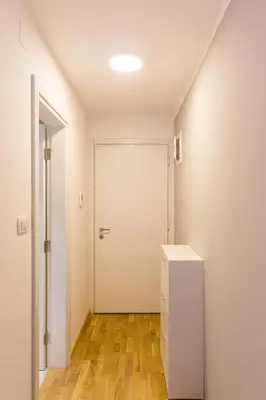 a room with a white door and a refrigerator at Central Budva apartment C15 in Budva