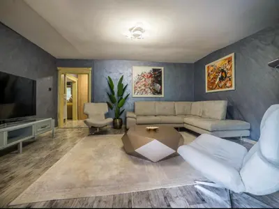 a living room with a couch and a tv at Villa Sun Castle in Kotor