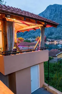 a balcony of a house with a view of the mountains at Villa Sun Castle in Kotor